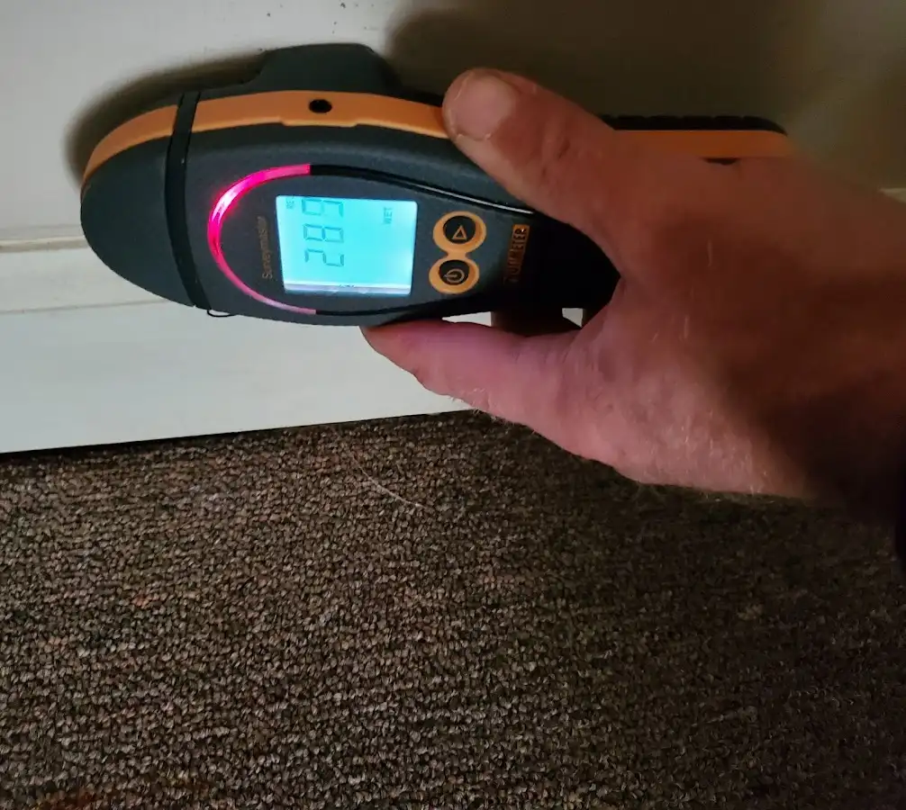 Moisture detection at baseboard during Storm Damage Restoration in Sevierville